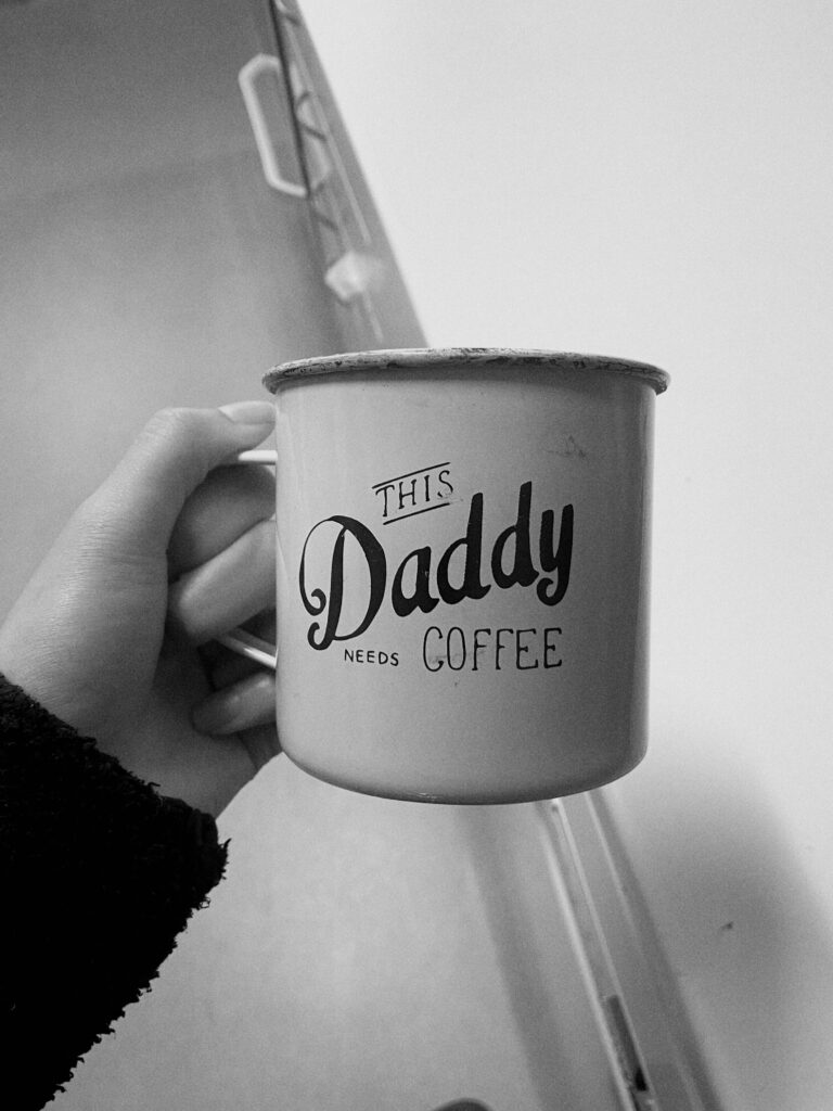 A picture of a mug with the text ''This Daddy Needs Coffee'' written on it.